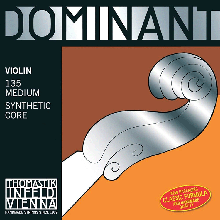 Packaging of Thomastik-Infeld Dominant violin strings showing a graphic of a violin scroll. Text includes "Dominant," "Violin 135 Medium Synthetic Core," and "New Packaging Classic Formula and Handmade Quality.