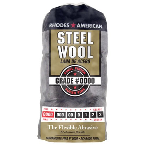 A package of Rhodes American steel wool labeled "Grade #0000" for final finish. The packaging highlights its super fine texture, with red and black colors, and text in English and Spanish.