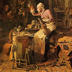 An older violin maker is seated at a cluttered workbench, examining a violin body. Various tools and instruments are scattered around the room. Another person is seen in the background reading. The setting appears to be a workshop.